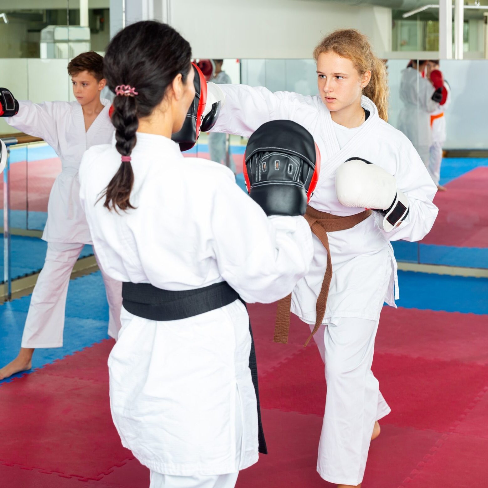 Young,Girls,And,Boys,In,Boxing,Gloves,Exercising,Jabs,During